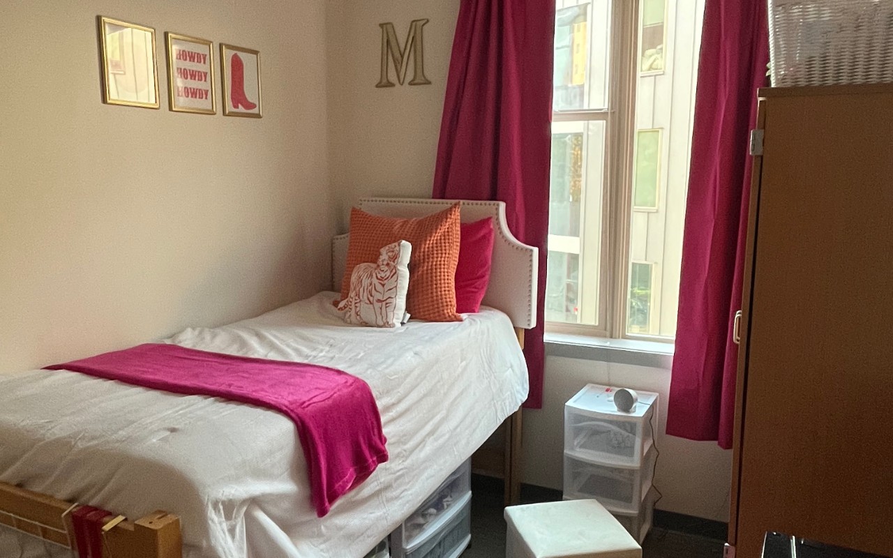 Dorm room decorated with curtains and pictures 