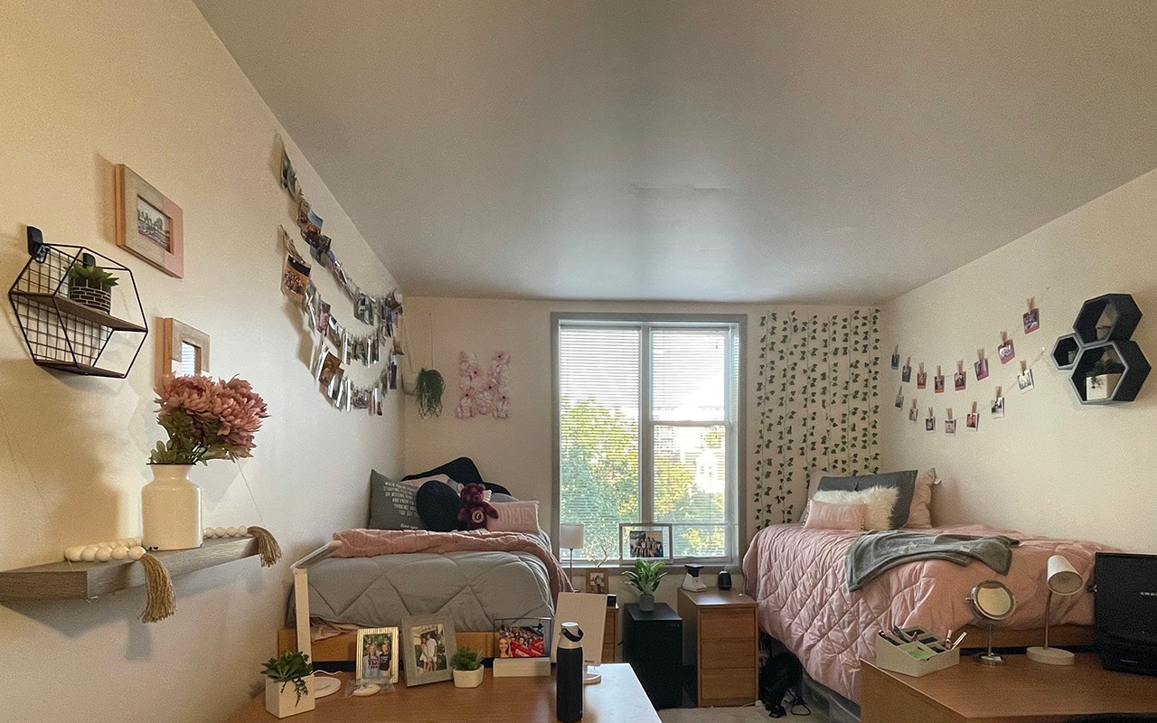 Turner Dorm room decorated with greenery, pictures, and a bright window 