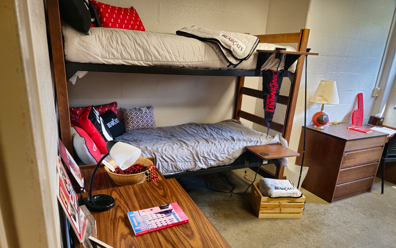 Double room in Dabney Hall showing a desk and chair next to bunk bed and another dresser on right